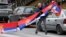 A man holds Serbian flags in North Mitrovica, Kosovo, following local Serbs' decision to quit their jobs in Kosovar institutions in November 2022.