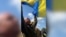 Flags, Tears, And Kneeling As Ukrainian Soldiers Return From Russian Captivity