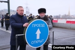 St. Petersburg Governor Aleksandr Beglov (left) and tycoon Igor Bukato open traffic on a renovated bridge.