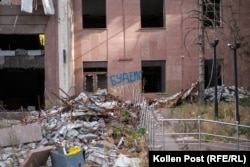 “We will live,” reads graffiti in the yellow and blue colors of Ukraine on a damaged building in Mykolayiv.