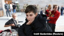 ARMENIA - A refugee boy from Nagorno-Karabakh waits upon his arrival at a temporary accommodation center in Goris, September 25, 2023.