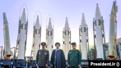 President Ebrahim Raisi (center) stands in front of Iranian missiles with other top officials last August.