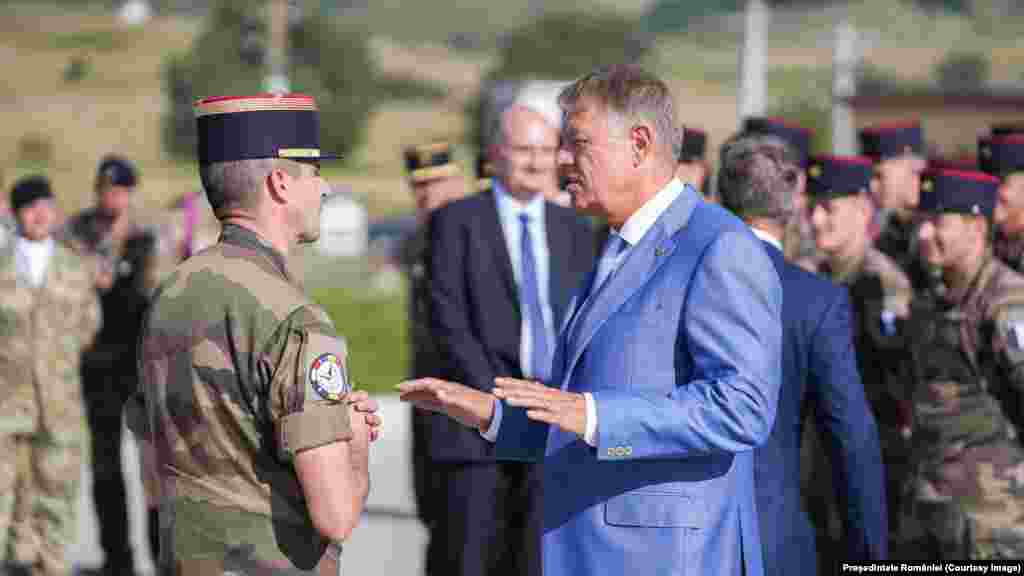 Romanian President Klaus Iohannis speaks with a NATO commander at a base in Cincu, central Romania, on September 5. Iohannis told reporters while visiting the NATO military base, &ldquo;I can tell you that no part of any drone or any other part of any other device landed in Romania.&nbsp;We have total control over our territory,&quot; adding,&nbsp;&ldquo;I checked absolutely everything and I can reassure the population.&quot;