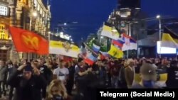 Знамето на РУСОВ (лево) на протестот против руската инвазија во Белград