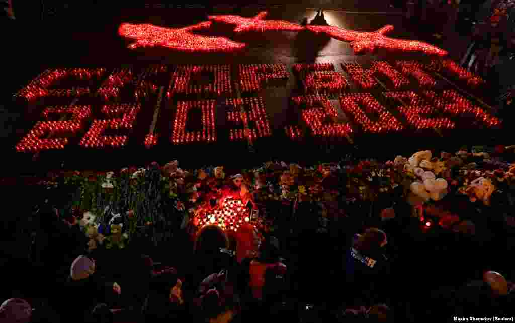 Lit candles forming the words &quot;We Mourn 22.03.2024&quot; are placed outside the Crocus City Hall concert venue on a national day of mourning on March 24.