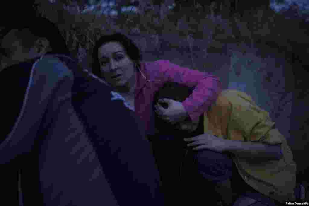 Ирина Сокерина ја држи својата ќерка Љубов Сокерина додека се кријат од руското гранатирање додека биле евакуирани од поплавената населба во Херсон.