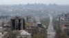 Damaged buildings are pictured in Mariupol on April 19, with the Azovstal steel works plant in the background.