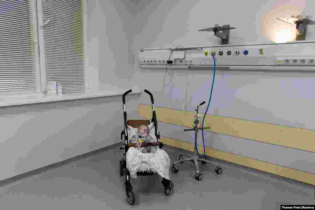 A 5-month-old orphan, rescued from the besieged city of Sumy, sleeps in his stroller at the Kyiv City Heart Center on March 20, 2022.