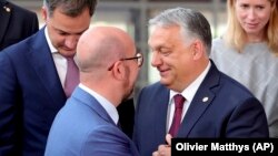 Premierul ungar Viktor Orban (dreapta) i-a scris recent președintelui Consiliului European, Charles Michel (stânga), cerând o „discuție strategică” cu privire la abordarea UE față de Ucraina în mai multe domenii.