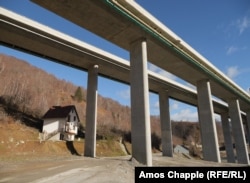 A house near Matesevo, Montenegro sits under an overpass from the Bar-Boljare highway.