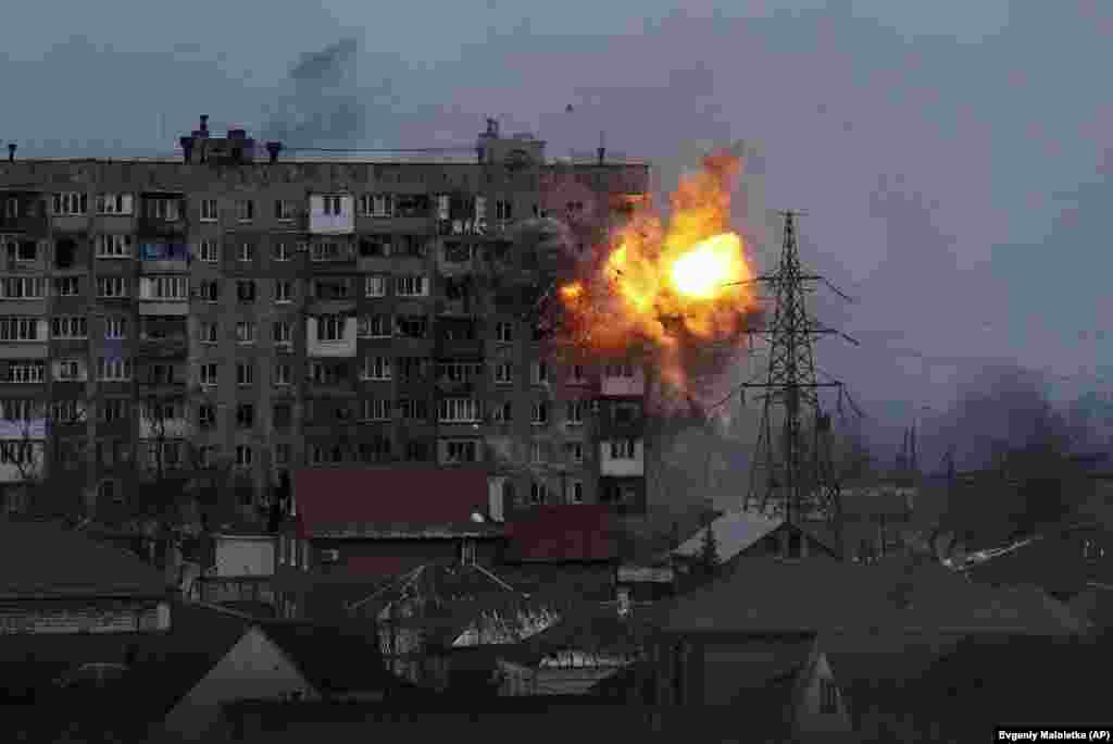 An explosion rips through an apartment building after a Russian tank fired on it in Mariupol on March 11, 2022.