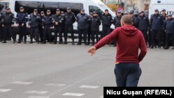 Un participant la protestul Partidului Șor din 23 octombrie se îndreaptă către PMAN. Câteva momente mai târziu acesta este reținut de polițiști pentru forțarea cordonului forțelor de ordine