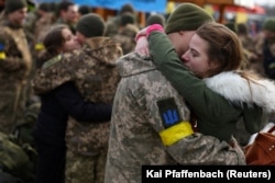 Ольга обіймає свого хлопця Володимира, коли вони прощаються перед відправленням Володимира ближче до лінії фронту під час вторгнення Росії до України. Львів, 9 березня 2022 року