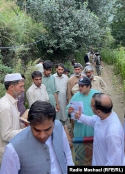 Shah Faisal (wearing the aquamarine shirt) is sheltering four families from Chel Deepu.