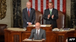 Afghan President Ashraf Ghani (center) is applauded by House Speaker John Boehner (right) and Vice President Joe Biden (left) as he addresses a joint session of Congress at the U.S. Capitol in Washington on March 25, 2015.