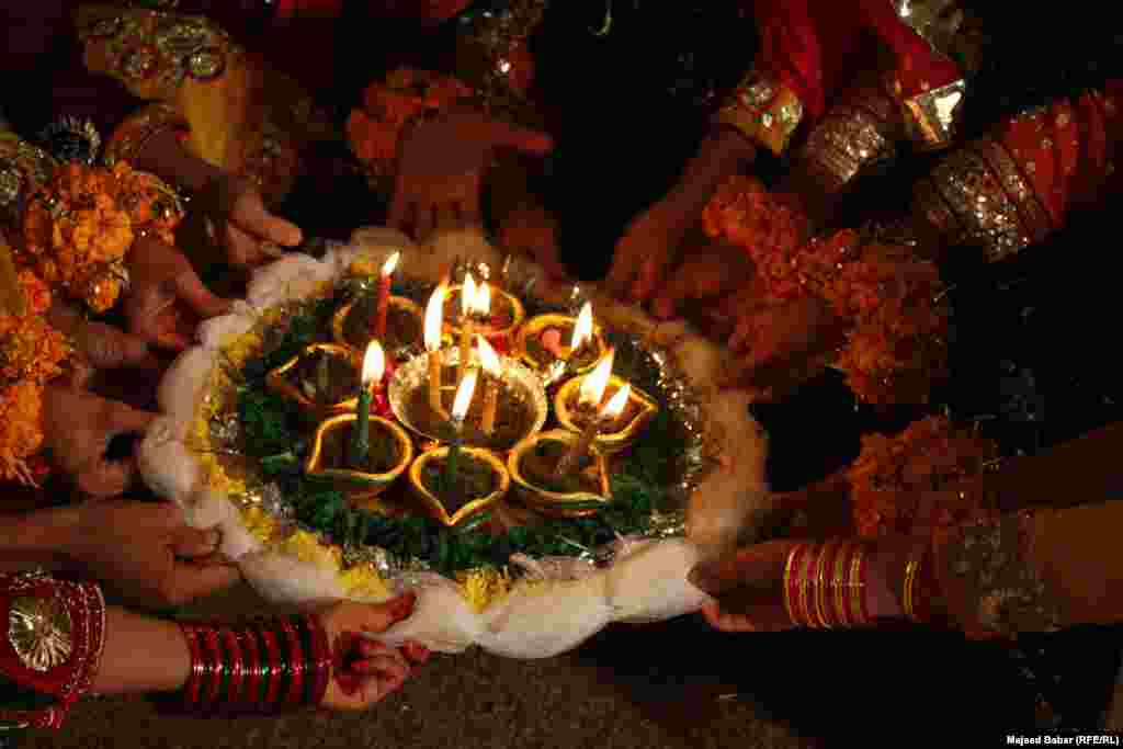 Candles, henna, flowers and colorful attire are in abundance.