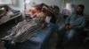 Afghan civilians who were injured in bomb blasts receive medical treatment at a hospital in Herat on May 24.
