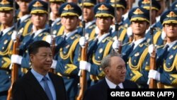 Kazakh President Nursultan Nazarbayev (R) reviews a military honor guard with Chinese President Xi Jinping at a welcome ceremony outside the Great Hall of the People in Beijing on June 7.