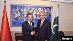 FILE: Pakistan's Foreign Minister Shah Mehmood Qureshi shakes hand with his Chinese counterpart Wang Yi.