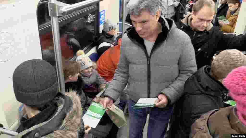 Nemtsov hands out leaflets inviting people to come to an opposition rally in Moscow in February 2015.