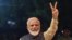 Indian Prime Minister Narendra Modi flashes the victory sign as he celebrates the victory in India's general elections at the party headquarters in New Delhi on May 23.