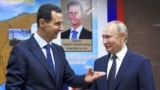 SYRIA – Syrian President Bashar Assad, left, gestures while speaking to Russian President Vladimir Putin during their meeting in Damascus, Syria, Jan. 7, 2020