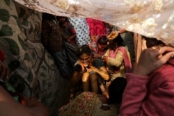 Geeta, 17, a Hindu refugee from Pakistan, reacts during a "haldi" ceremony before getting married at a Hindu refugee settlement situated in a woodland area in New Delhi.