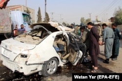 Afghan security officials inspect the car in which Dayee was riding.
