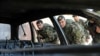 FILE: Afghan army soldiers inspect a vehicle which was used in a suicide attack in Farah province.