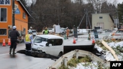 د جاپان په ټوکوهو ښاریه کې یو ګاډی د زلزلې له وجې د وران شوي سړک خرابېدو له وجې بند پاتې دی - انځور ډېسېمبر ۹، کال ۲۰۲۵