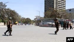 FILE: Afghan soldiers in front of the communication ministry during the attack on April 20.