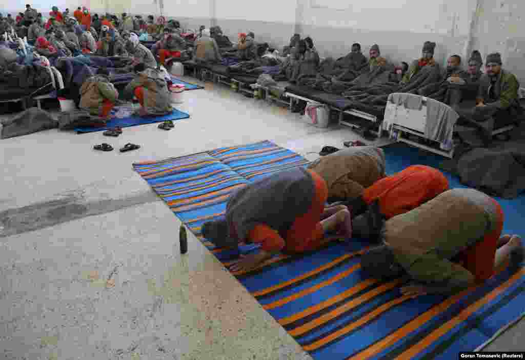 Suspects pray inside a hospital in the Hasaka prison.