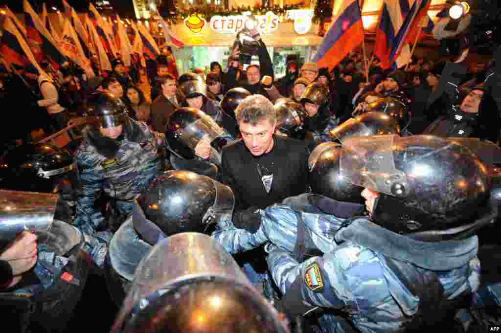 Police encricle Nemtsov as he speaks at an anti-Putin rally in Moscow in 2011 -- the second mass protest in the Russian capital in as many days -- demanding fresh elections after alleged electoral fraud.