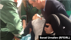 Березовка ауылының тұрғыны Қазбек Ермекбаев талып қалған 17 жасар қызы Динараны жедел жәрдем көлігіне апара жатыр. Орал, 21 қаңтар 2015 жыл.   