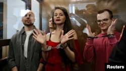(Left to right:) Russian journalists Sergei Karelin, Konstantin Gabov, Antonina Favorskaya and Artyom Kriger stand in a defendant's cage in Moscow accused of taking part in the activities of an "extremist" organization. They received prison sentences of five and a half years in April after what Reporters Without Borders described as a "sham" trial. 