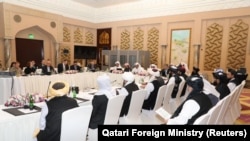 Taliban negotiators and Qatari officials meet in Doha in March 2019.
