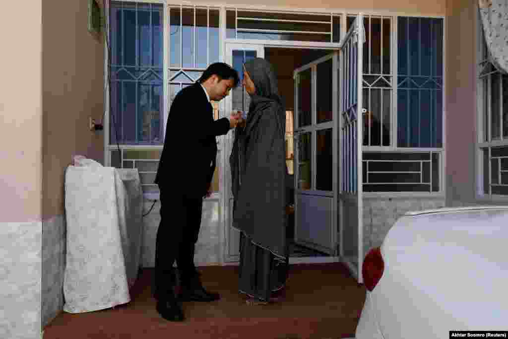 Sahil kisses his mother goodbye before leaving home inside the walled neighborhood. The 30-year-old says that &quot;though all these checkpoints were established for our security, we feel we were also cut off from other communities.&quot;