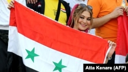A female supporter of the Syrian national team attends the FIFA World Cup 2018 qualification football match between Syria and Iran at Azadi Stadium in Tehran on September 5.