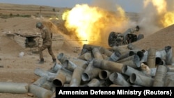 An Armenian soldier fires artillery during the military conflict over the breakaway region of Nagorno-Karabakh on October 4.