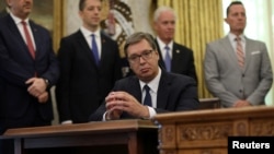 Претседателот на Србија Александар Вучиќ слуша додека американскиот претседател Доналд Трамп зборува за време на церемонијата со косовскиот премиер Авдула Хоти во Белата куќа во Вашингтон, САД, 4 септември 2020 година