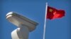 CHINA -- A Chinese flag flies near a Hikvision security camera monitoring a traffic intersection in Beijing, October 8, 2019