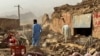 People search the debris of damaged buildings in the aftermath of an earthquake in Samangan Province, Afghanistan, on November 3. 