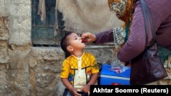 A boy receives polio vaccine drops during an anti-polio campaign in a low-income neighborhood in Karachi on April 9.
