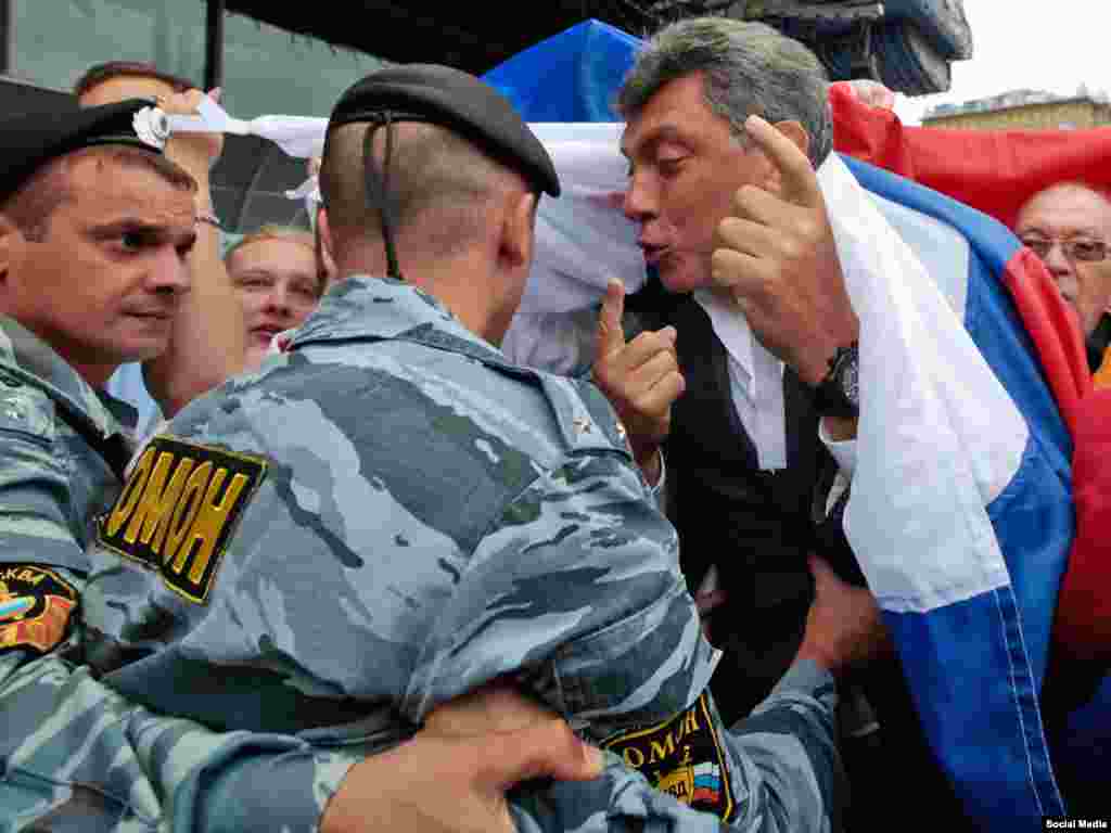 Nemtsov confronts police during an opposition march in Moscow in 2010.