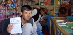 Said Wali, the owner of Hewad Internet Café provides satellite Internet in Tarinkot.