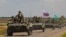 Бронированный конвой российских войск въезжает в оккупированную Россией часть Запорожской области Украины, 23 июля 2022 года