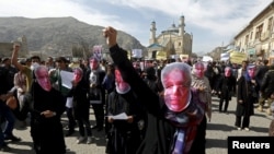 IFILE: Afghan protestor wear masks during a protest to condemn the killing of 27-year-old woman, Farkhunda, who was lynched after a healer allegedly incited a mob in Kabul in 2015.