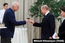 Russian film director Nikita Mikhalkov (left) enjoys a toast with Russian President Vladimir Putin at the Mariinsky Theatre in St. Petersburg in 2016.