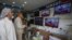 FILE: Pakistani viewers watch news bulletins on television in Karachi.