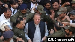 Former Pakistani Prime Minister Nawaz Sharif arrives at a court in Lahore on October 11.